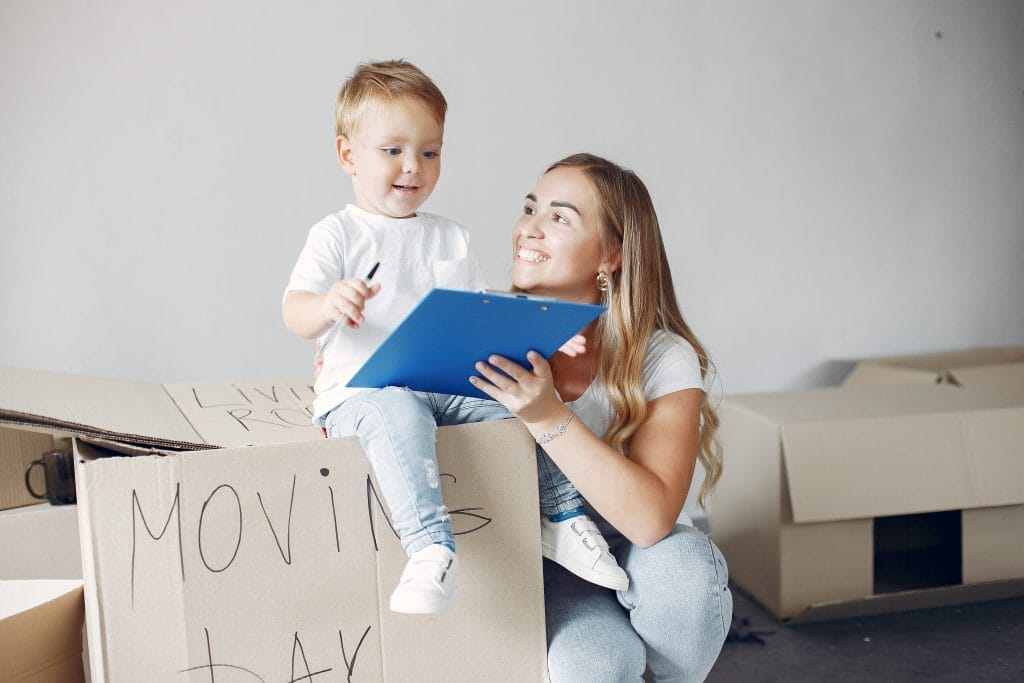 Family moving. People use a boxes. Little boy with moher.