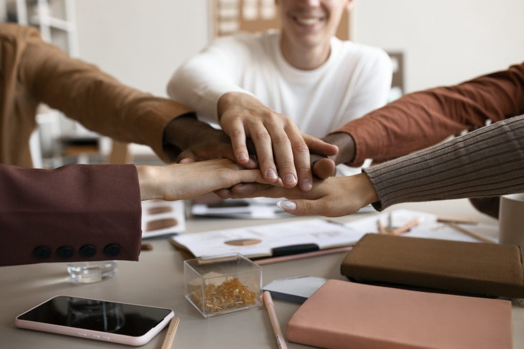 side-view-people-putting-hands-together
